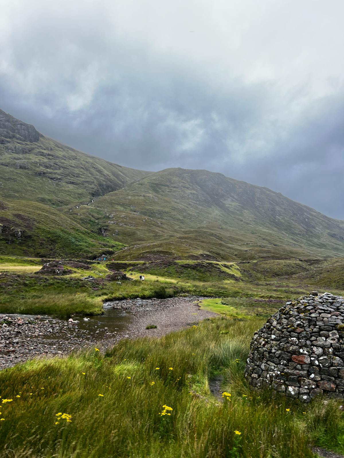 Rugged Scottish Highlands landscape with stone cairn