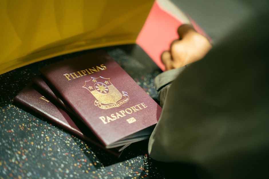 Several different passports held together at an airport before a group trip to the UK