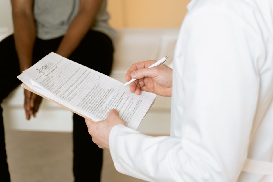 Healthcare professional reviewing a traveller's medical form, illustrating that the UK ETA asks no health declaration
