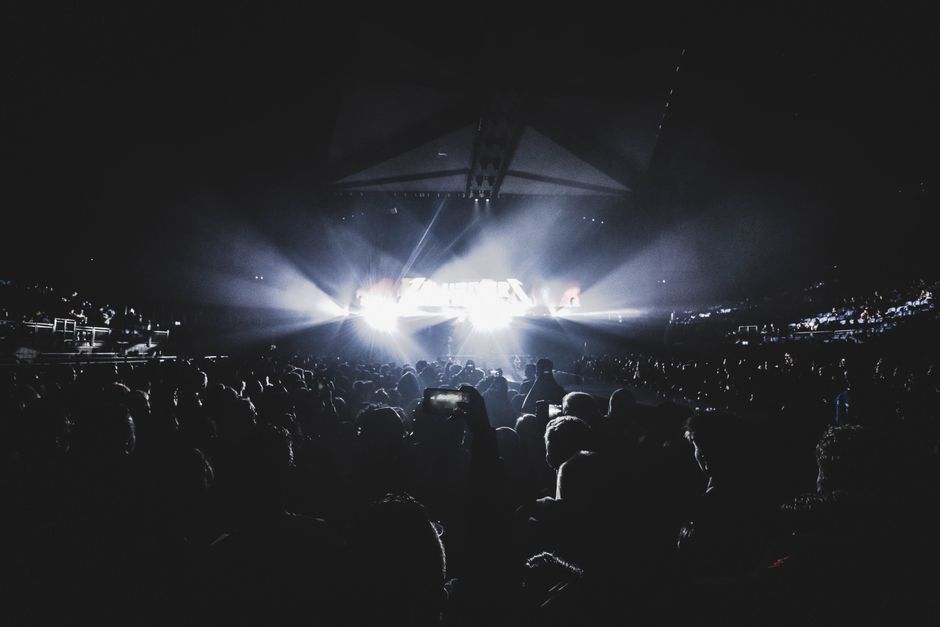 Concert crowd with stage lights at a UK stadium show needing a UK ETA