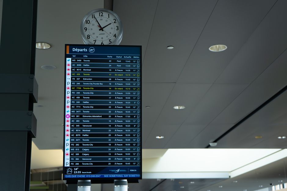 Anxious traveller watching a departure board while awaiting ETA approval
