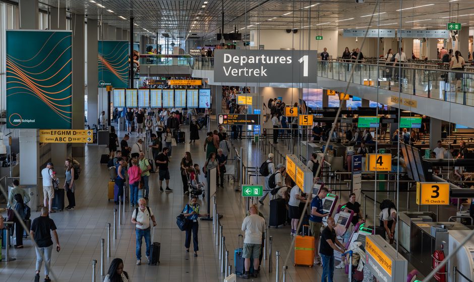 International travellers at a UK airport departures hall requiring a UK ETA