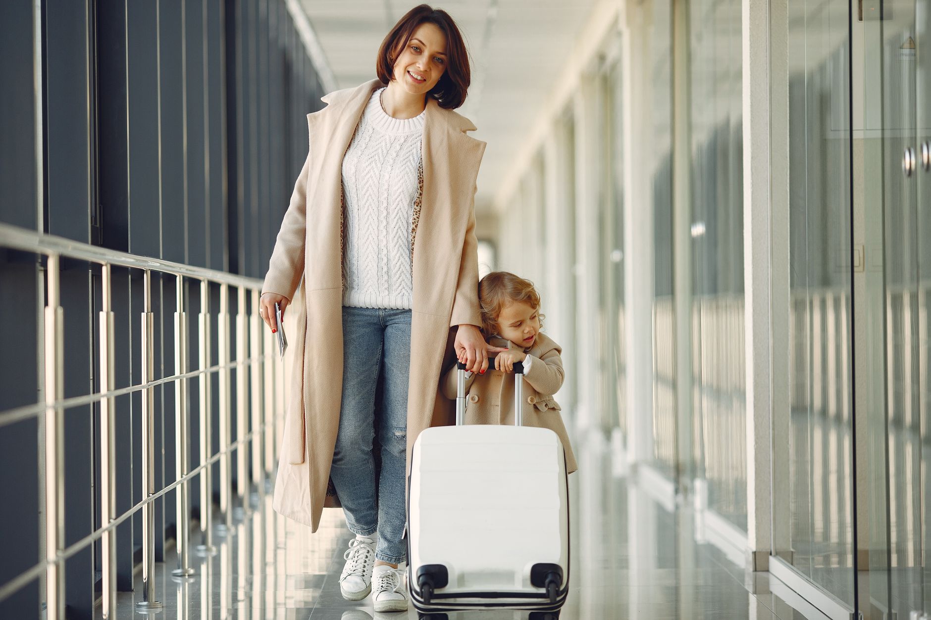 Parents with children at an airport before a family trip to the UK