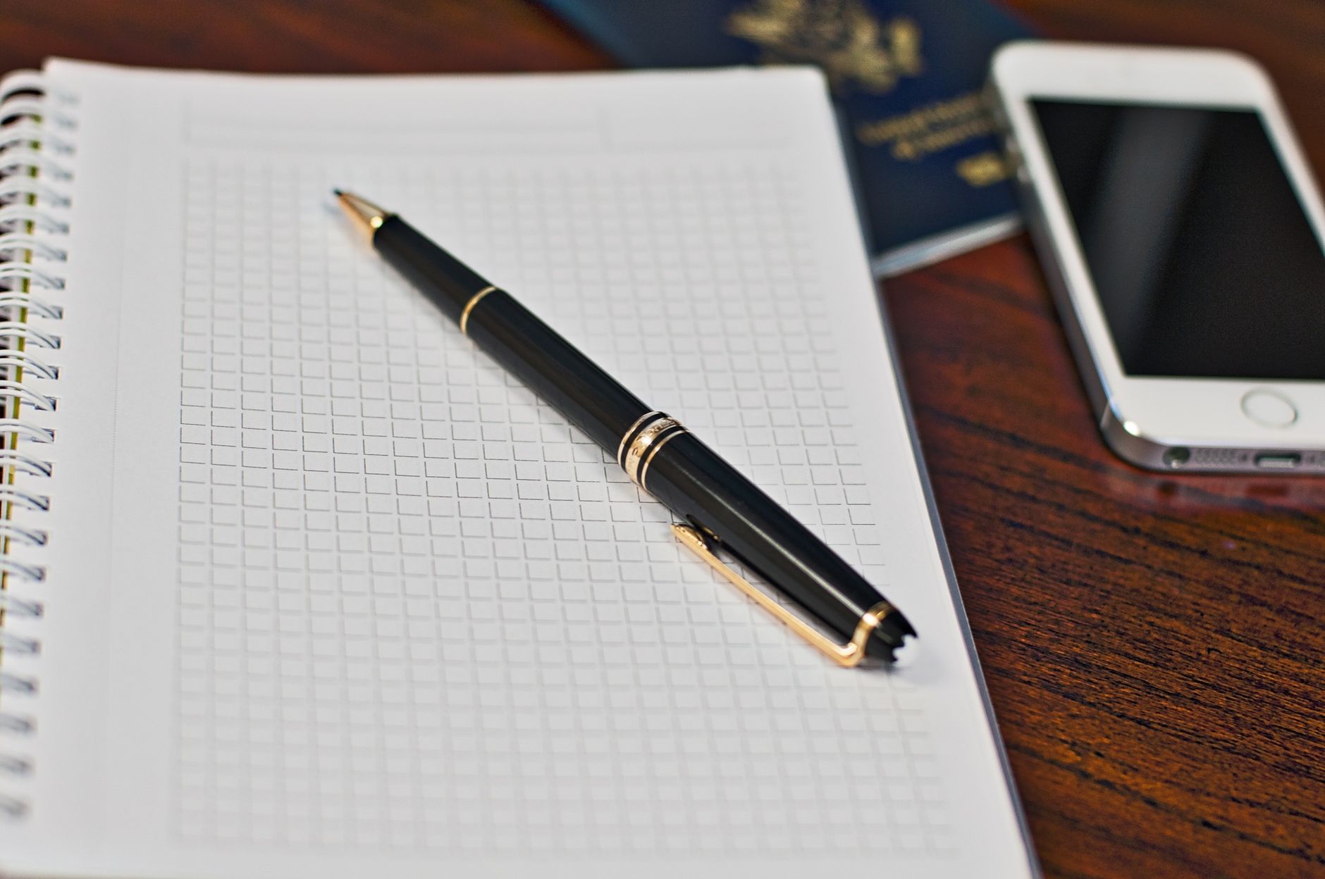 Biometric passport and a printed face photo laid out on a desk for an application