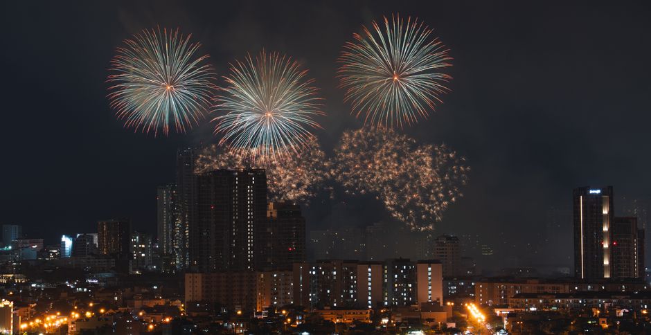 Families watching a Bonfire Night fireworks show with sparklers in London
